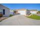 Home exterior with attached garage and a spacious driveway at 547 Richburg St, The Villages, FL 32162