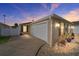 Tan house exterior with attached garage at dusk at 547 Richburg St, The Villages, FL 32162