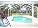 Inviting kidney-shaped pool with screened enclosure and backyard views at 307 Water Shore Dr, Leesburg, FL 34748