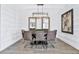 Spacious dining area with a modern chandelier and an accent wall at 15615 Vetta Dr, Montverde, FL 34756