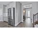 Stainless steel refrigerator in kitchen with white cabinets and wood floors at 15603 Vetta Dr, Montverde, FL 34756