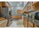 Kitchen boasts stainless steel appliances and ample wood cabinetry at 919 Patrick St, Kissimmee, FL 34741