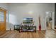 Living room with two TVs, a media console, and entryway view at 919 Patrick St, Kissimmee, FL 34741
