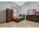 Bright bedroom with double bed, dresser, and wardrobe at 919 Patrick St, Kissimmee, FL 34741
