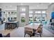 Open concept community room with tables and chairs, perfect for gatherings at 7740 Sandy Ridge Dr # 106, Reunion, FL 34747