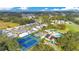 Aerial view of community tennis courts, pool, and clubhouse at 818 Old Oaks Ln, Leesburg, FL 34748