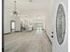 Open concept living room with kitchen and modern light fixture at 3611 Se 132Nd Pl, Belleview, FL 34420