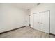 Spacious bedroom with double door closet and light gray wood flooring at 3611 Se 132Nd Pl, Belleview, FL 34420