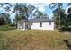 Single-story house with covered patio and grassy yard at 3611 Se 132Nd Pl, Belleview, FL 34420