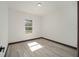 Well-lit bedroom with wood-look floors and window at 3610 Se 131St Ln, Belleview, FL 34420
