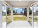 Covered back patio with view of backyard and surrounding trees at 3610 Se 131St Ln, Belleview, FL 34420