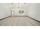 Bright living room with vinyl flooring and a modern chandelier at 3610 Se 131St Ln, Belleview, FL 34420