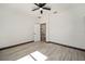 Bright bedroom with wood-look floors and access to hallway at 3610 Se 131St Ln, Belleview, FL 34420
