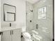 Modern bathroom with white vanity, glass shower, and hexagon tile floor at 3610 Se 131St Ln, Belleview, FL 34420