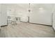 Open concept living room and kitchen area with high ceilings and modern lighting at 3610 Se 131St Ln, Belleview, FL 34420