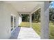 Covered back patio with view of backyard and surrounding trees at 3610 Se 131St Ln, Belleview, FL 34420