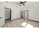Spacious bedroom with ceiling fan and access to bathroom at 3610 Se 131St Ln, Belleview, FL 34420