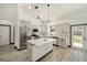 Modern kitchen with a large island, stainless steel appliances, and light gray cabinets at 3610 Se 131St Ln, Belleview, FL 34420