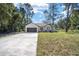 Single story home with dark gray garage door and landscaping at 3610 Se 131St Ln, Belleview, FL 34420
