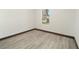 Bright bedroom with wood-look floors and large window at 3610 Se 131St Ln, Belleview, FL 34420
