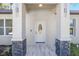 Front entrance with modern door and stone accents at 3610 Se 131St Ln, Belleview, FL 34420