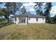 Single story home with covered patio and grassy backyard at 3610 Se 131St Ln, Belleview, FL 34420