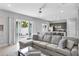 Open living space with sectional sofa and view of kitchen and patio at 7740 Sandy Ridge Dr # 106, Reunion, FL 34747