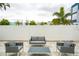 Relaxing patio area with seating and a white fence at 7740 Sandy Ridge Dr # 106, Reunion, FL 34747