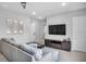 Living room with sectional sofa and large flat-screen TV at 7740 Sandy Ridge Dr # 106, Reunion, FL 34747