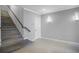 Bright entryway with modern staircase and wood-look flooring at 7740 Sandy Ridge Dr # 106, Reunion, FL 34747