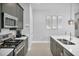 Modern kitchen with stainless steel appliances and white cabinetry at 7740 Sandy Ridge Dr # 106, Reunion, FL 34747