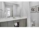 Double vanity with modern gray cabinets and a large mirror at 7740 Sandy Ridge Dr # 106, Reunion, FL 34747