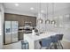 Modern kitchen with island and stainless steel appliances at 7740 Sandy Ridge Dr # 106, Reunion, FL 34747