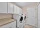 Laundry room with washer, dryer, cabinets, and countertop at 815 Forest Breeze Path, Leesburg, FL 34748