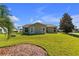 Back exterior view of house, showcasing landscaping at 815 Forest Breeze Path, Leesburg, FL 34748