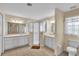 Bathroom with double vanity, shower, and toilet at 815 Forest Breeze Path, Leesburg, FL 34748