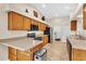 Kitchen with stainless steel appliances and wood cabinets at 815 Forest Breeze Path, Leesburg, FL 34748