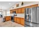 Modern kitchen with stainless steel appliances and wood cabinets at 815 Forest Breeze Path, Leesburg, FL 34748