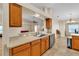 Kitchen with light countertops, wood cabinets, and a breakfast bar at 815 Forest Breeze Path, Leesburg, FL 34748