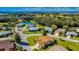 Aerial view showcasing the home's location near a pond and golf course at 815 Forest Breeze Path, Leesburg, FL 34748