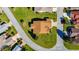 An overhead view of a house on a corner lot with well-manicured lawn at 815 Forest Breeze Path, Leesburg, FL 34748