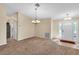 Spacious living room with carpet, chandelier, and access to other rooms at 815 Forest Breeze Path, Leesburg, FL 34748