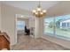 Bright dining room features a chandelier and view into an office at 815 Forest Breeze Path, Leesburg, FL 34748