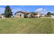 Landscaped yard with a large green lawn at 815 Forest Breeze Path, Leesburg, FL 34748