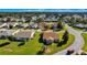 Aerial view showing a house nestled in a neighborhood with lush green spaces at 815 Forest Breeze Path, Leesburg, FL 34748