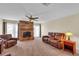 Living room with a stone fireplace and leather furniture at 815 Forest Breeze Path, Leesburg, FL 34748