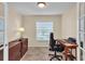 Home office with built-in desk and ample natural light at 815 Forest Breeze Path, Leesburg, FL 34748