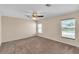 Spacious bedroom with two windows and ceiling fan at 815 Forest Breeze Path, Leesburg, FL 34748
