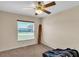Well-lit bedroom with ceiling fan and carpeting at 815 Forest Breeze Path, Leesburg, FL 34748
