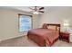 Cozy bedroom with wood bed frame and ceiling fan at 815 Forest Breeze Path, Leesburg, FL 34748